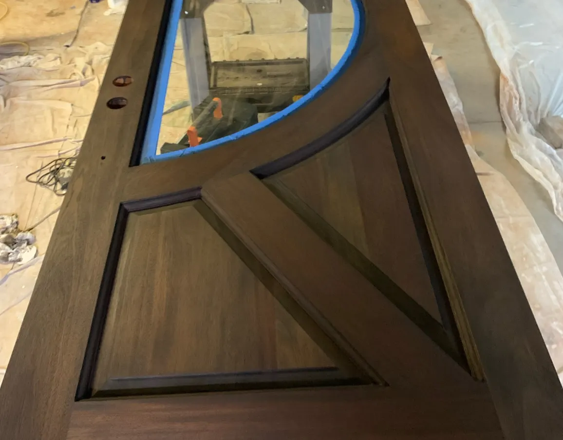 Close up of a custom wood door panel being finished
