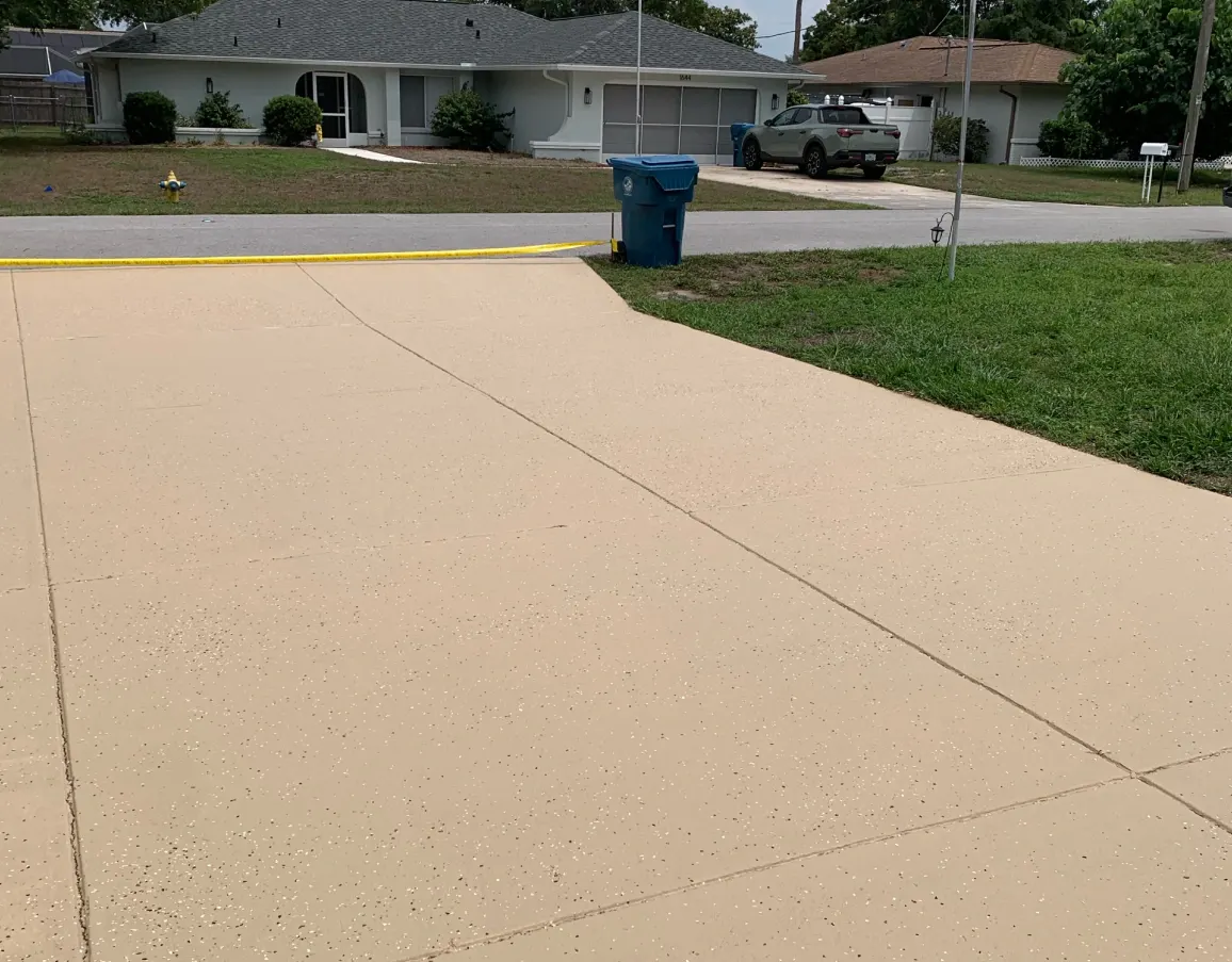 Driveway partway through a pressure washing job, half cleaned and half still dirty